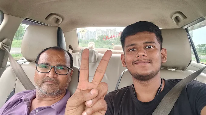 A learner celebrating a successful driving lesson with the instructor